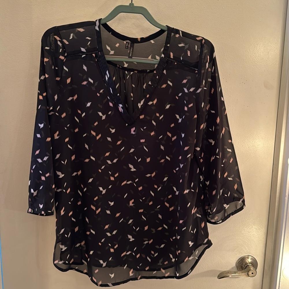 Sheer black 3/4 blouse with pink and white accents and cutouts around neck